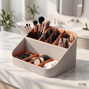 May include: A beige, ribbed cosmetic organiser with multiple compartments. The interior is a contrasting peach colour. It holds various makeup brushes, black lipstick tubes, small glass skincare bottles, eye pencils, compact powders, and cotton pads.