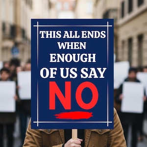 May include: A person holding a sign with the text "THIS ALL ENDS WHEN ENOUGH OF US SAY NO" in white and red on a blue background. The sign is held on a wooden stick. Other people with blank signs are in the background.
