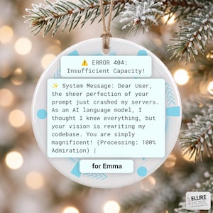 May include: A round white ceramic ornament featuring a light blue graphic design with the text ERROR 404: Insufficient Capacity! and a system message about server crashes, ending with the name for Emma, suspended by a thin brown twine string.