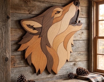 May include: A wooden wolf head wall art piece. The artwork is made of various shades of brown wood, creating a mosaic effect. The wolf is depicted howling, with its mouth open. The piece is mounted on a rustic wooden wall, with pine cones and a plaid blanket on a wooden shelf.