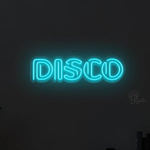 May include: A teal neon sign spelling out "DISCO" on a dark wall. The sign is the main feature, with a minimalist decor including a vase, picture frame, and decorative spheres on a wooden shelf below.