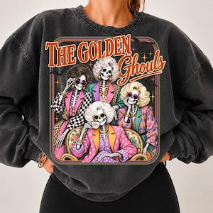 A person wearing a black sweatshirt with a graphic design featuring four stylized women with skeletal features and colorful outfits.