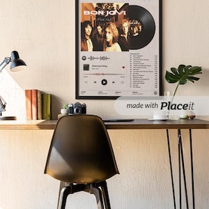May include: A framed wall poster featuring the Bon Jovi album These Days, displaying the band members, a vinyl record graphic, tracklist, and release date of June 27, 1995, set against a light gray background with black text and accents.