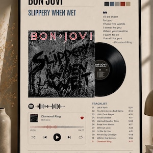 May include: A framed poster featuring the Bon Jovi album Slippery When Wet, released August 18, 1986. It displays the album cover, a black vinyl record, a tracklist, lyrics from Diamond Ring, a Spotify-style player interface, and metadata.