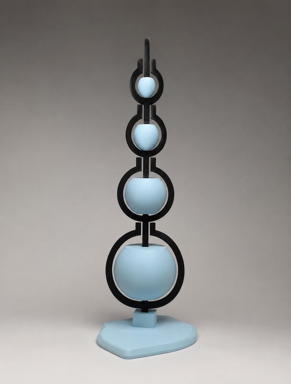 A self-balancing gravity sculpture that sits on your desk looking like it defies physics — the kind of thing that makes visitors stop and stare.