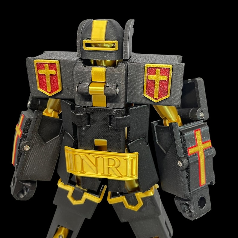 May include: A black and gold robot toy with red cross emblems. The robot has the letters INRI on its chest. The toy is made of plastic and has articulated joints.