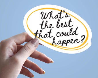 May include: A white oval sticker with the text "What's the best that could happen?" in black script, outlined in yellow, held against a light blue background.