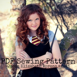 May include: A girl wearing a black dress with a red and gold striped tie, holding a black wand. The text "PDF Sewing Pattern Queen Elizabeth Aprons ©2015" is on the image.