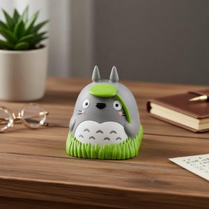 May include: A set of three ceramic mugs with a speckled, matte finish. The mugs are in shades of cream, light gray, and dark gray. Each mug has a simple, modern design and a rounded handle. The mugs are stacked on top of each other.