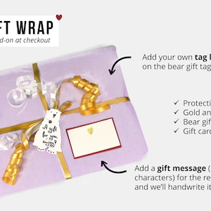 Gift-wrap option—lavender paper with gold and silver ribbons, bear gift tag, and handwritten gift message.