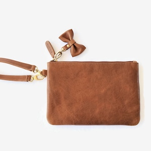 OOPSIE - Leather wristlet clutch with bow tie - BEAUTY IMPERFECTIONS