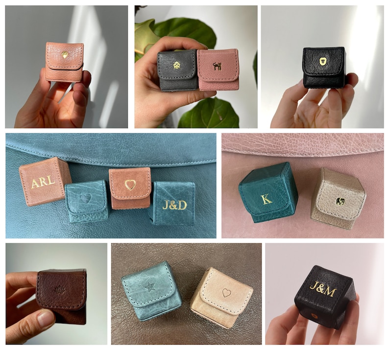 May include: An assortment of small, personalised leather boxes in various colours, including brown, black, pink, blue, and green. Each box features a different letter or symbol, such as "ARL", "J&D", "K", and a heart.