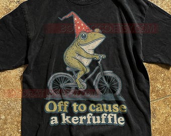 Off To Cause A Kerfuffle T-Shirt, Frog On Bicycle Whimsical Retro Cartoon, Funny Animal Quote Tee, Transparent Graphic
