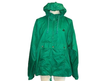 May include: A bright green hooded anorak jacket with a half-zip closure and a front pocket with snap closures. The jacket has a drawstring at the hood and hem. A small logo is visible on the upper chest.