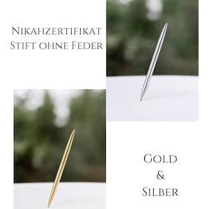 May include: A sleek, slender pen with a metallic finish, available in gold and silver. The text NIKAHZERTIFIKAT STIFT OHNE FEDER and GOLD & SILBER is displayed alongside the pens, which are shown standing upright on a white surface.