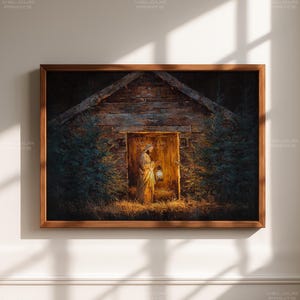 May include: A framed print depicts a person holding a lantern in front of a wooden structure. The person is wearing a long, light-colored robe. The structure has a wooden door and is surrounded by greenery. The artwork is set in a dark, mysterious environment.