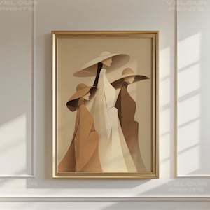 May include: A framed art print featuring three stylized figures wearing wide-brimmed hats and long coats. The figures are rendered in shades of beige, brown, and white, creating a minimalist and elegant aesthetic. The artwork is framed in a gold-colored frame.