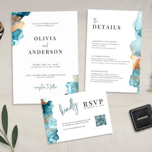 May include: Wedding stationery set with teal and gold watercolour design. The invitation includes the names Olivia and Anderson, date, time, and venue details. RSVP card with QR code and details card.
