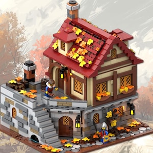 Op de afbeelding: Een gedetailleerd Lego-model van een huis in middeleeuwse stijl met een rood dak versierd met gele bladaccenten. Het gebouw heeft beige en bruine muren, stenen accenten en een kleine binnenplaats met een minifiguur. De scène speelt zich af in een herfstlandschap.