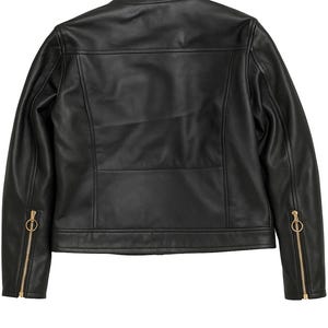 May include: Black leather jacket with a round collar and gold-colored zippers on the sleeves. The back of the jacket features a horizontal seam across the upper back and a vertical seam down the center.