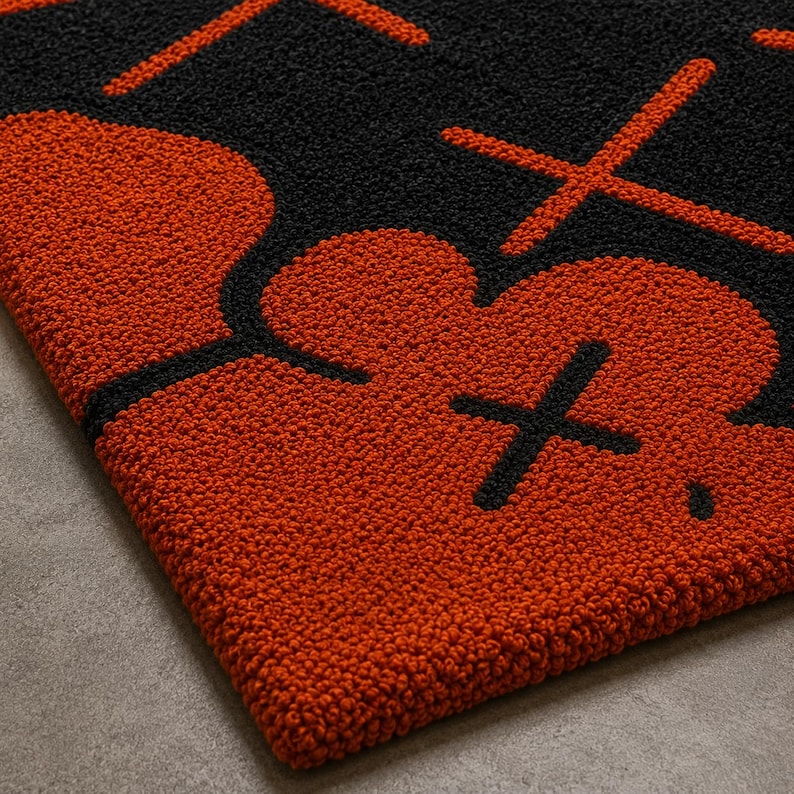 Modern urban art carpet with bold orange and black graphic artwork.