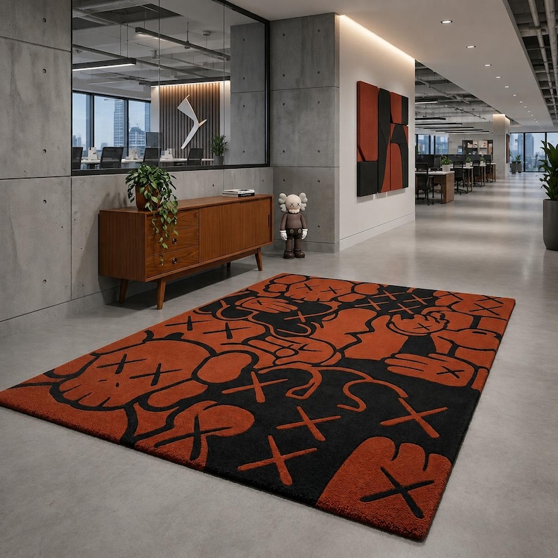 Handmade orange and black KAWS inspired tufted rug displayed in a modern office interior.