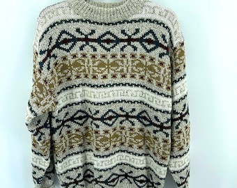 May include: A beige sweater with a multi-colored geometric pattern. The pattern includes shades of brown, red, green, and blue.