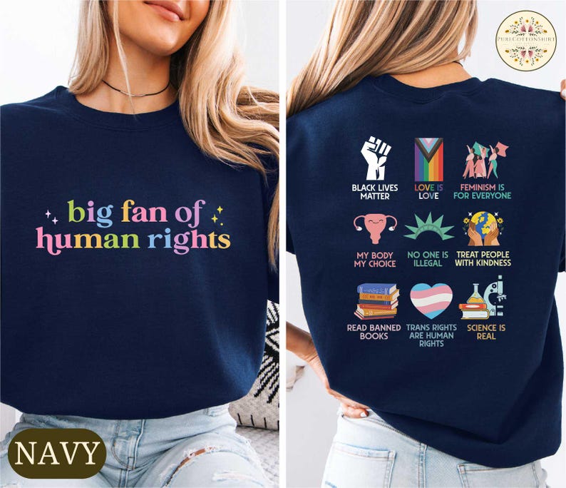 May include: Navy blue sweatshirt with the text "big fan of human rights" in colorful letters on the front. The back of the shirt features various social justice symbols and phrases, including "Black Lives Matter" and "Love is Love."