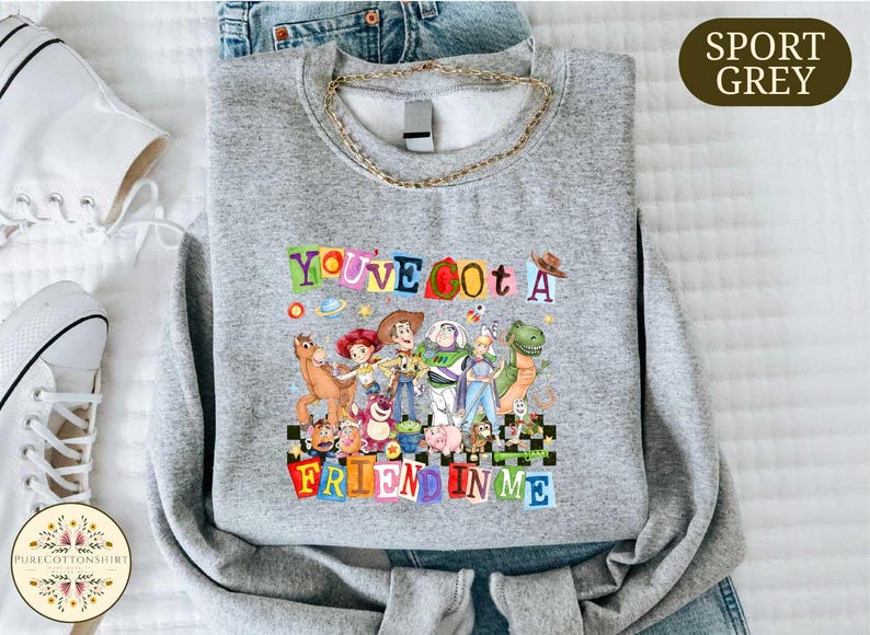 A gray sweatshirt with a colorful graphic design featuring characters from the Toy Story movie, along with the text "You've Got a Friend in Me".