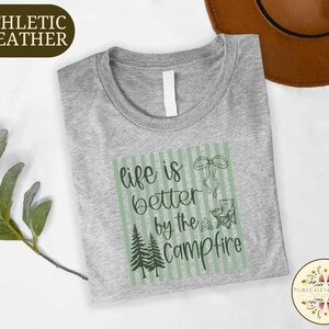 a gray t-shirt with a green and white graphic design, along with a brown hat and some greenery, all placed on a white background.