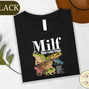 a black t-shirt with a graphic design of a group of colorful frogs.