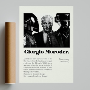 May include: A black and white poster featuring Giorgio Moroder with two figures in helmets. The poster includes text that reads "Giorgio Moroder" and a quote about his work. A brown cylindrical tube is on the left.