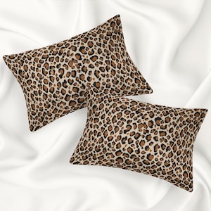 May include: Two brown and black leopard print pillowcases. The pillowcases are made of a soft, comfortable fabric and are perfect for adding a touch of style to any bedroom.