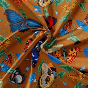 May include: A brown fabric with a repeating pattern of colourful butterflies. The butterflies are in various poses and have different wing patterns. The fabric has a subtle sheen and a soft texture.