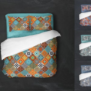 May include: A bed with a white duvet cover and two patterned pillowcases. The duvet cover has a colorful geometric pattern with orange, blue, and brown tones. The pillowcases have a similar pattern but are in a lighter blue color.