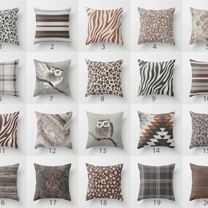 May include: Twenty different throw pillow designs featuring various patterns and colors, including animal prints, plaid, stripes, and geometric designs. The pillows are all square and have a neutral color palette of brown, gray, and white.
