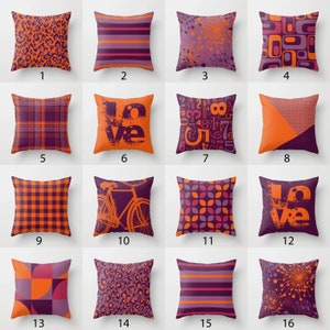May include: A set of 16 throw pillow covers featuring various geometric patterns in shades of orange and purple. The patterns include stripes, polka dots, plaid, and abstract designs.