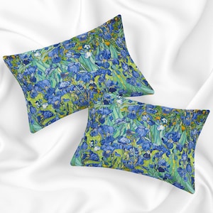 May include: Two decorative pillow covers featuring a vibrant blue and green floral pattern inspired by Vincent van Gogh's Irises painting.
