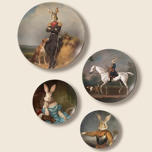 May include: Set of four decorative plates featuring anthropomorphic rabbits in historical attire. The plates showcase rabbits in military uniforms, riding a horse, and in elegant dresses, set against classical backgrounds. A unique and whimsical home decor item.