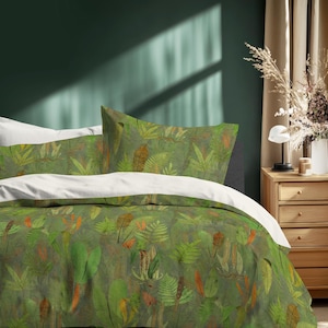 May include: A bed with a green and brown botanical print duvet cover and pillowcases. The bedding features a pattern of leaves and foliage in shades of green, orange, and brown. White sheets are visible beneath the duvet cover.