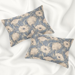 May include: Two decorative pillowcases with a floral pattern. The pillowcases feature a light blue background with beige flowers and leaves.