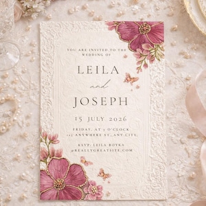 May include: Ivory wedding invitation with floral and butterfly accents. The invitation features the names "Leila and Joseph" and event details. The design includes pink flowers and gold accents, with the text "You are invited to the wedding of".
