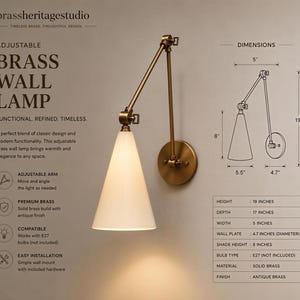 May include: An adjustable brass wall lamp with a conical white shade and an antique brass finish. The lamp features an articulated arm and a circular wall mount. Technical diagrams show a 48.26 cm height, 43.18 cm depth, and 12.7 cm width.