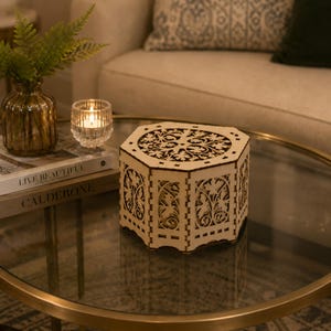 May include: An octagonal wooden box featuring intricate laser-cut floral patterns on the lid and side panels. The light-colored wood has dark, burnt edges from the cutting process, creating a high-contrast design with visible interlocking joints.
