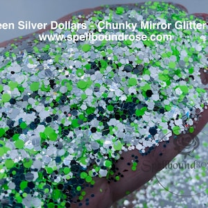 May include: A handful of chunky glitter mix in green, silver, and black. The glitter is a mix of shapes, including circles and hexagons. The text "Green Silver Dollars - Chunky Mirror Glitter Mix" is visible.