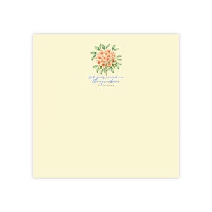 May include: A square pale yellow card featuring a watercolour illustration of a cluster of peach-coloured flowers with green leaves. Below the floral design, the text reads, "Set your mind on things above" followed by "COLOSSIANS 3:2" in blue script.