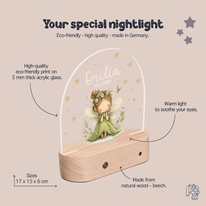 The image is an advertisement for a fairy-themed nightlight. It features a clear acrylic glass dome with a fairy illustration, a wooden base, and various descriptive text highlighting the product's eco-friendly, high-quality, and German-made nature.