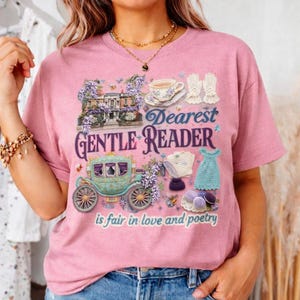 May include: Pink t-shirt with a graphic design featuring a carriage, teacup, gloves, and the text "Dearest Gentle Reader is fair in love and poetry." The design includes floral and architectural elements.