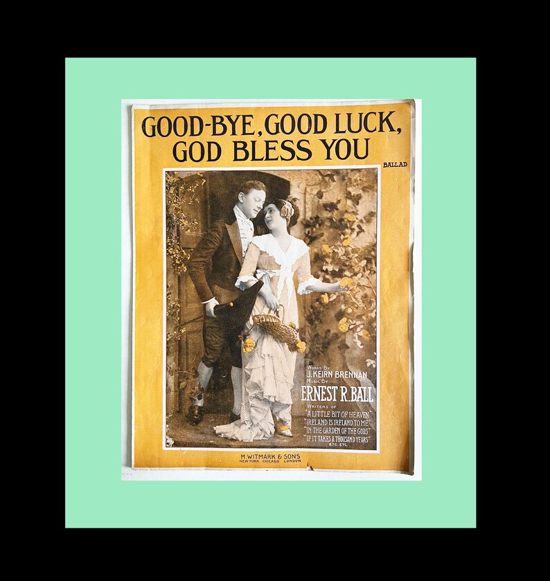 May include: A vintage sheet music cover featuring a couple in a garden setting. The title of the song is "Good-Bye, Good Luck, God Bless You." The music is by Keirn Brennan and the words are by Ernest R. Ball. The cover is printed on yellowed paper with a faded, sepia-toned image.