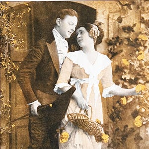 May include: A sepia-toned photograph of a couple standing near a doorway. The man is wearing a suit and a hat, and the woman is wearing a dress with a lace collar and a basket. They are both looking at each other.